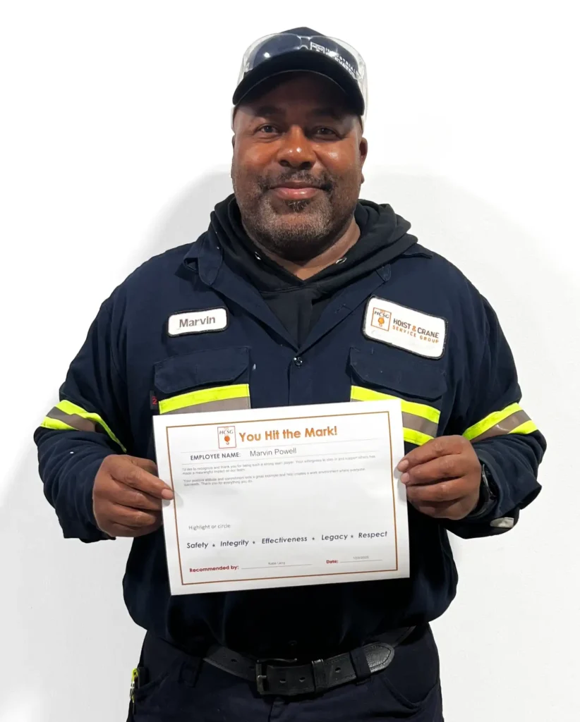 Marvin P holding five marks certificate